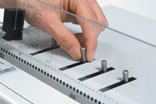 Disengagement pins allow for quick accurate centering for the common paper sizes.